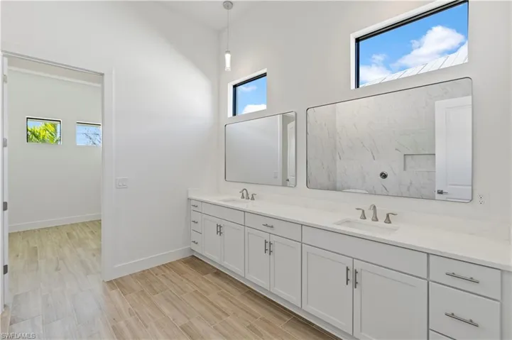Full bathroom with double vanity and wood tiled floors