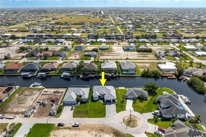 Aerial perspective of suburban area featuring a nearby body of water