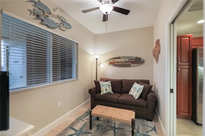 Living room with light wood-type flooring and ceiling fan