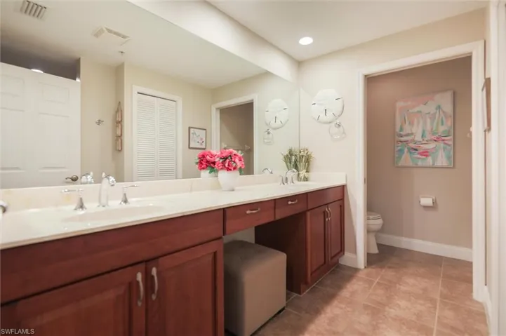 Bathroom featuring tile patterned flooring, vanity, and toilet