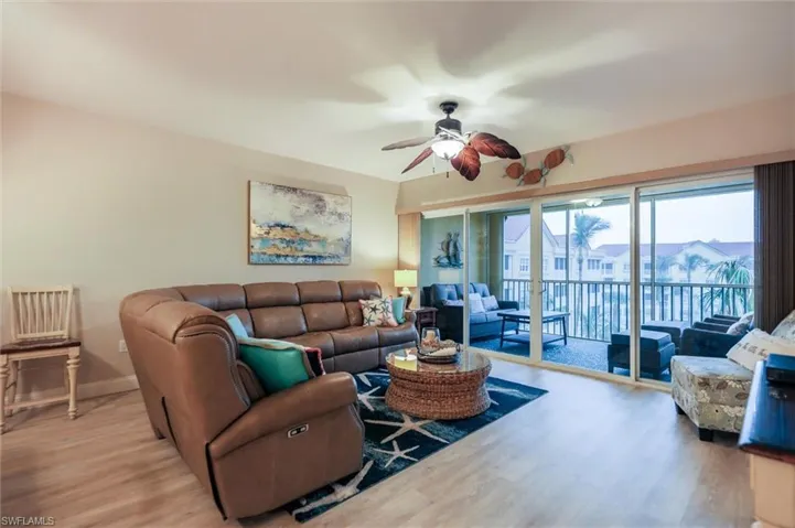 Living room featuring ceiling fan and light wood-type flooring