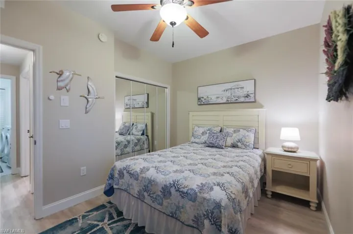 Bedroom featuring a closet, light hardwood / wood-style flooring, ceiling fan, and washer / clothes dryer