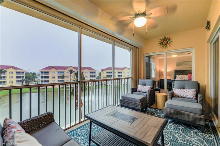 Sunroom with a water view and ceiling fan