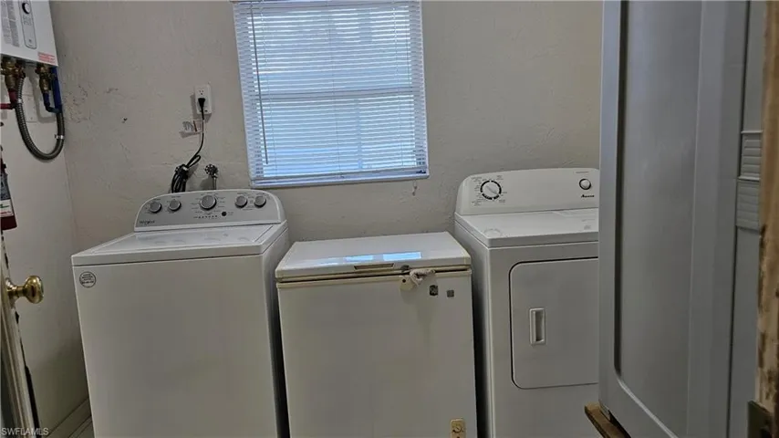 Washroom with separate washer and dryer. Tankless  water heater August 2023 also upgraded electrical panel