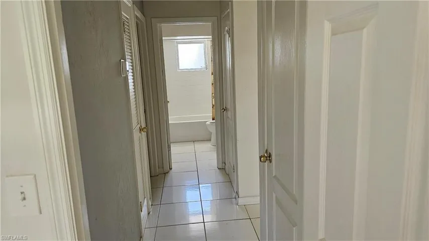 Corridor featuring light tile patterned floors