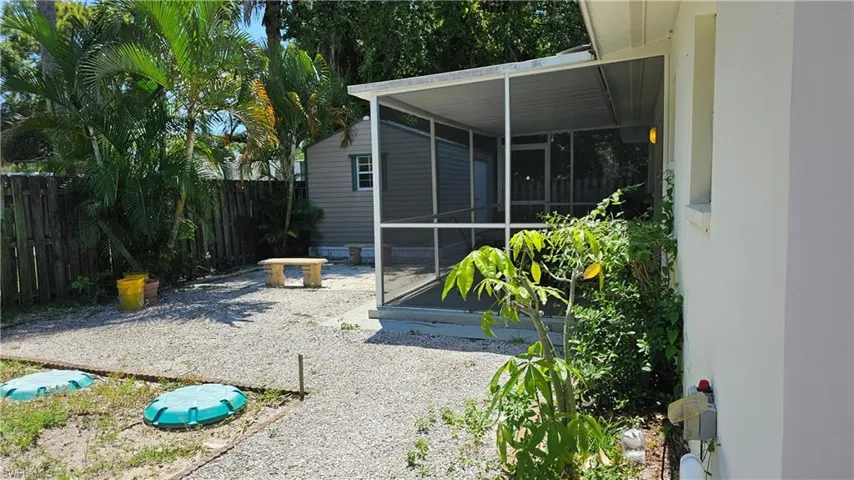 Backyard view of shed and screened lanai