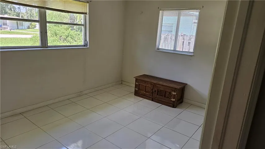 Empty room featuring light tile patterned floors