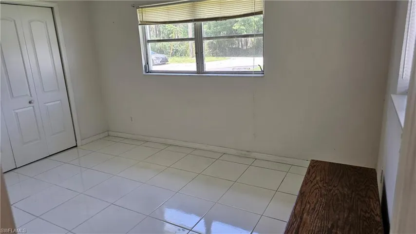 Unfurnished bedroom with light tile patterned floors and a closet