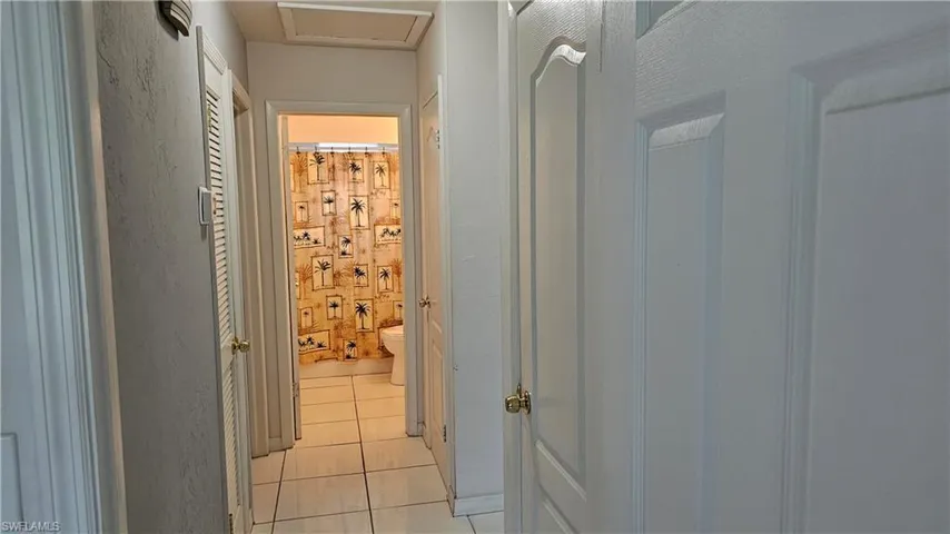 Hallway featuring light tile patterned floors