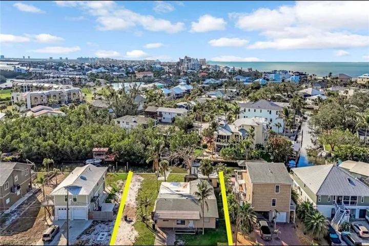 Drone / aerial view with a water view and a residential view