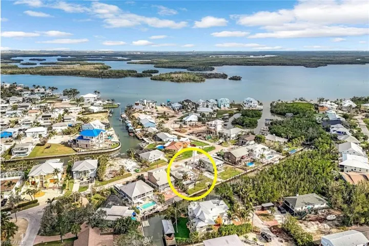 Drone / aerial view with a water view and a residential view