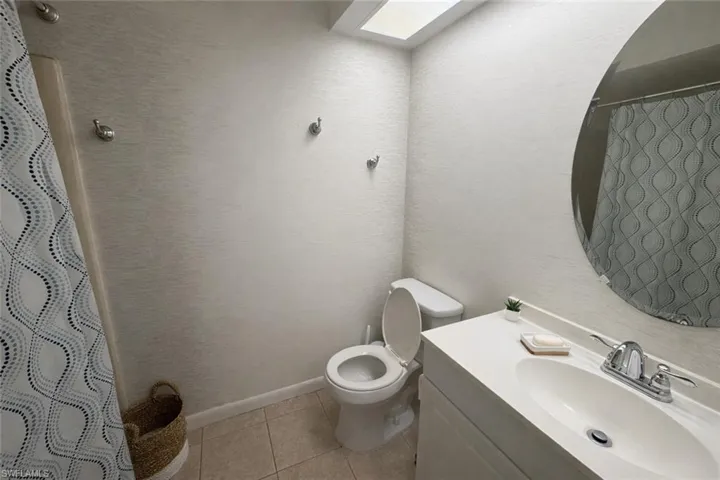 Guest bathroom accessed through the hallway.