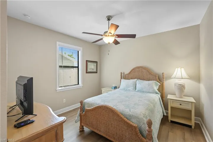 Bedroom with wood finished floors and ceiling fan
