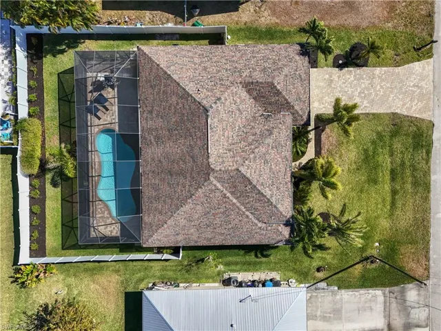 Aerial view of property and surrounding area featuring a pool area