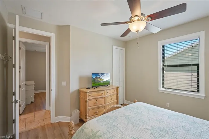 Bedroom featuring light wood finished floors, ceiling fan, and a closet