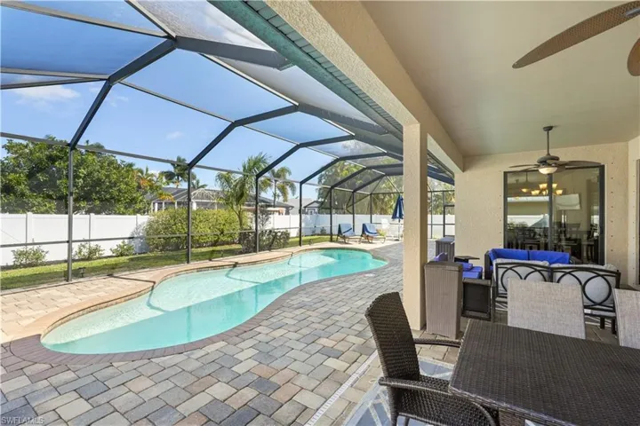 View of swimming pool featuring an outdoor lounge area, patio surround, a sunroom, a lanai, and a fenced backyard