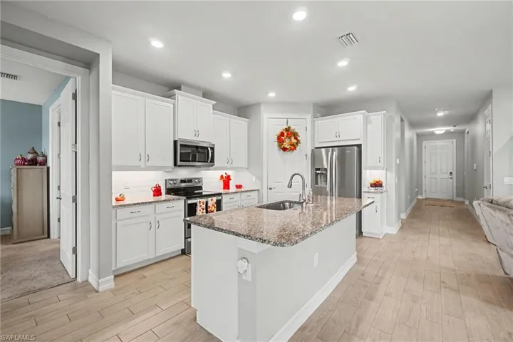 Open Kitchen area looking towards front hallway and door.