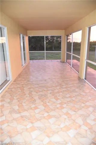 Unfurnished sunroom featuring stone finish flooring