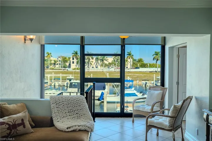 Living room overlooking Naples Bay Marina