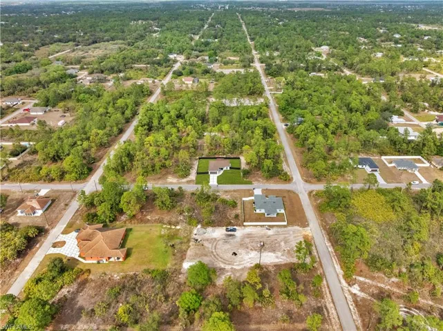Aerial view of property's location with a forest