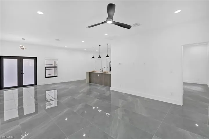 Unfurnished living room featuring french doors, recessed lighting, and a ceiling fan