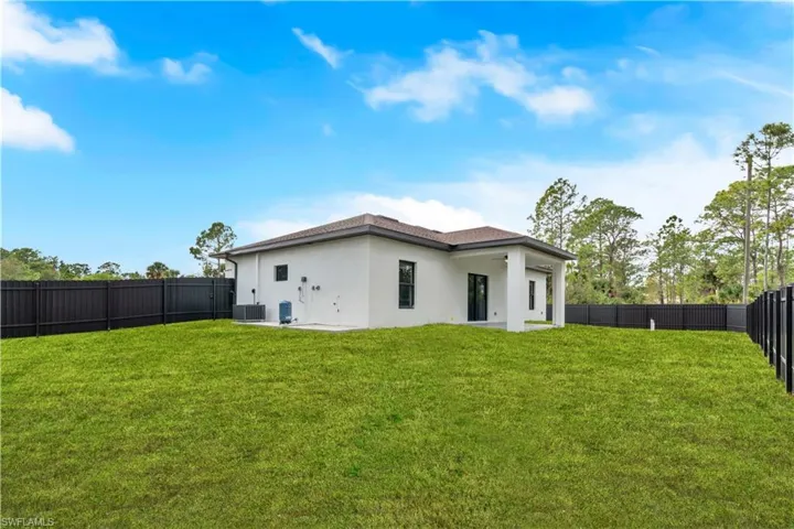Back of property featuring stucco siding, a fenced backyard, and a patio