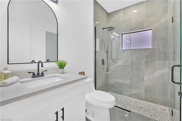 Full bathroom featuring a stall shower and vanity