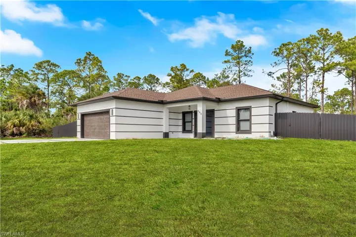 View of front of property with a garage and driveway