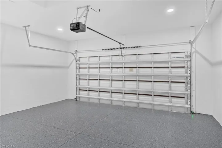 Garage with recessed lighting and a garage door opener