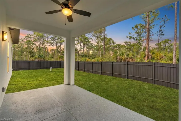 Patio terrace at dusk featuring a patio area, a fenced backyard, and ceiling fan
