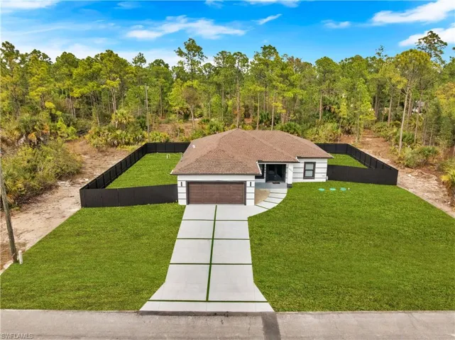 View of front of property featuring concrete driveway, an attached garage, and roof with shingles