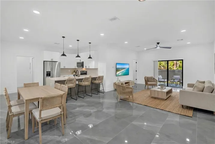 Living room with ceiling fan and recessed lighting