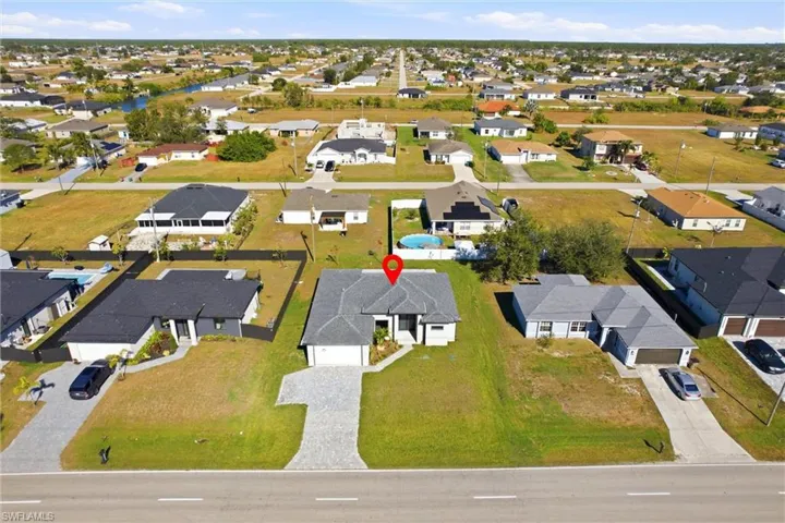 Aerial overview of property's location featuring nearby suburban area