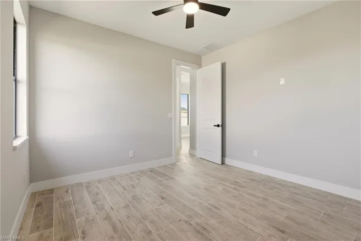 Empty room featuring wood tiled floors and ceiling fan