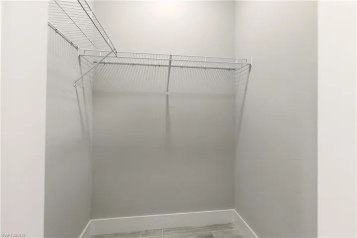 Spacious closet with wood finish floors