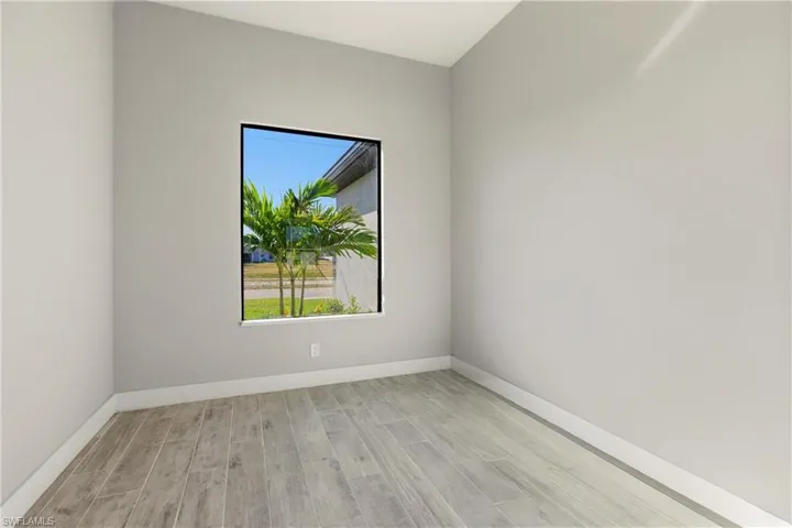 Bonus/office room with wood finish floors and baseboards