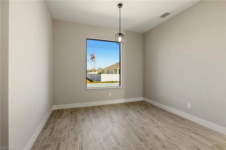 Bedroom with wood finish floors and baseboards