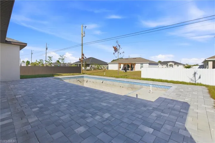 View of swimming pool with a patio area and a fenced backyard