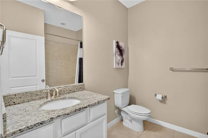 Full bath with vanity, tile patterned floors, and a shower with curtain