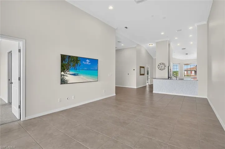 Unfurnished living room featuring crown molding, tile patterned floors, and recessed lighting