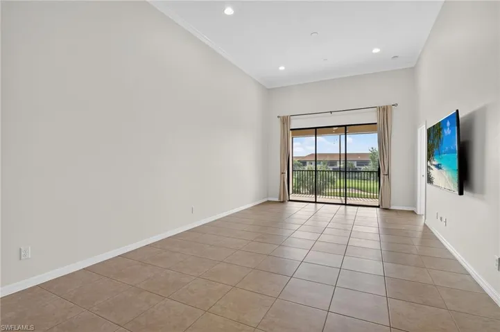 Empty room with light tile patterned flooring, crown molding, and recessed lighting