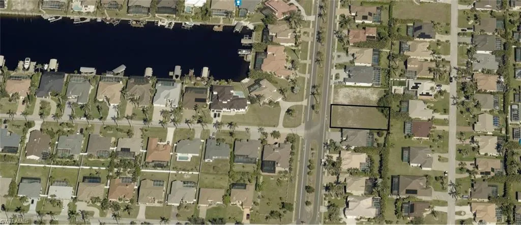 Aerial overview of property's location with nearby suburban area and a nearby body of water