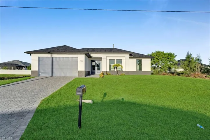 Contemporary single-story residence with a gray tile roof and a paver driveway