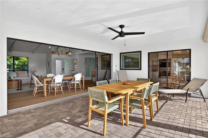 Sunroom featuring brick flooring and plenty of natural light