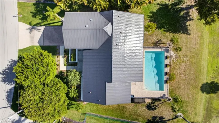 View of subject property featuring a pool