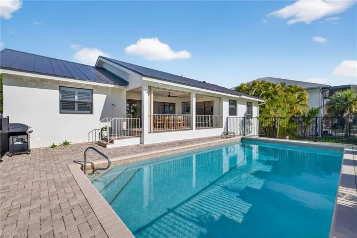View of pool with patio surround and grilling area