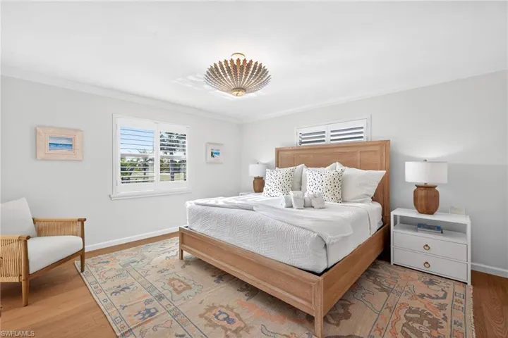 Primary Bedroom featuring wood finished floors and ornamental molding
