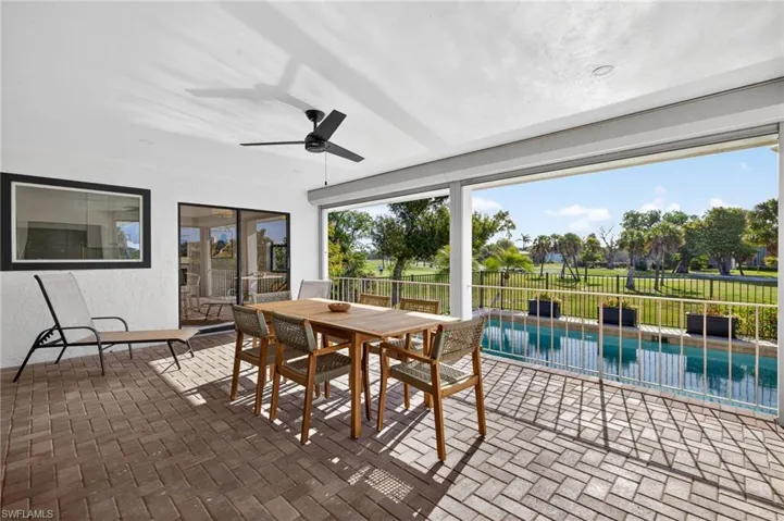 Sunroom featuring brick flooring and plenty of natural light