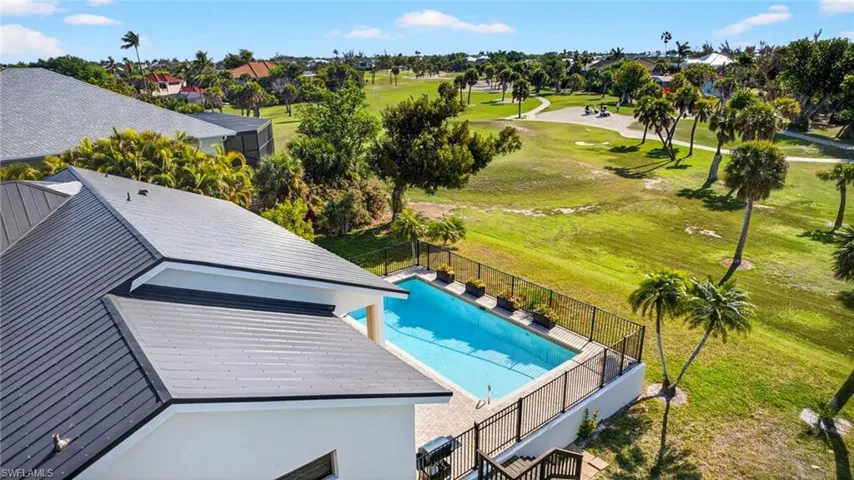 View of swimming pool with golf course view and patio surround