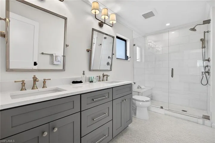Primary Bathroom featuring double vanity, a stall shower, and recessed lighting